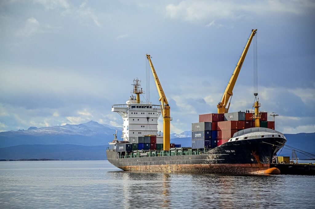 Container ship being loaded by cranes at a busy port