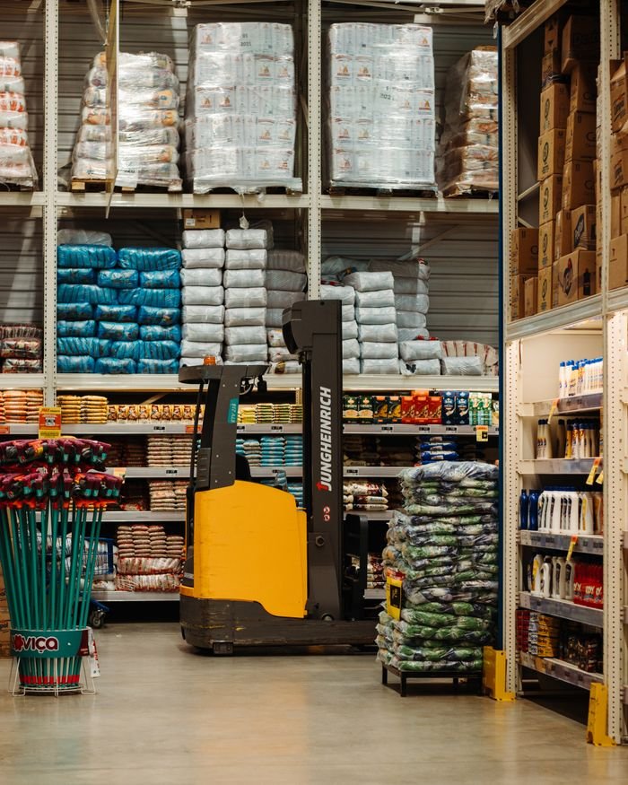 A warehouse with stacked goods, shelves, and a forklift in Brazil.