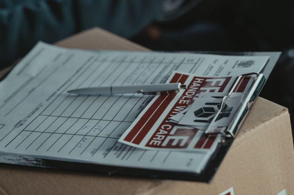 Clipboard with shipping paperwork and a pen