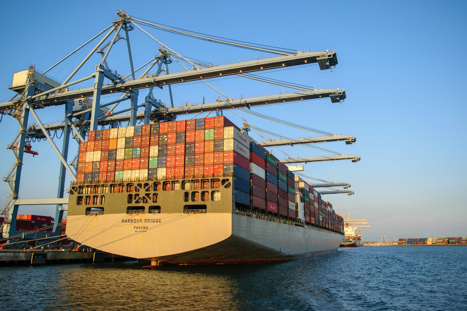 Cargo ship in a harbour under a blue sky