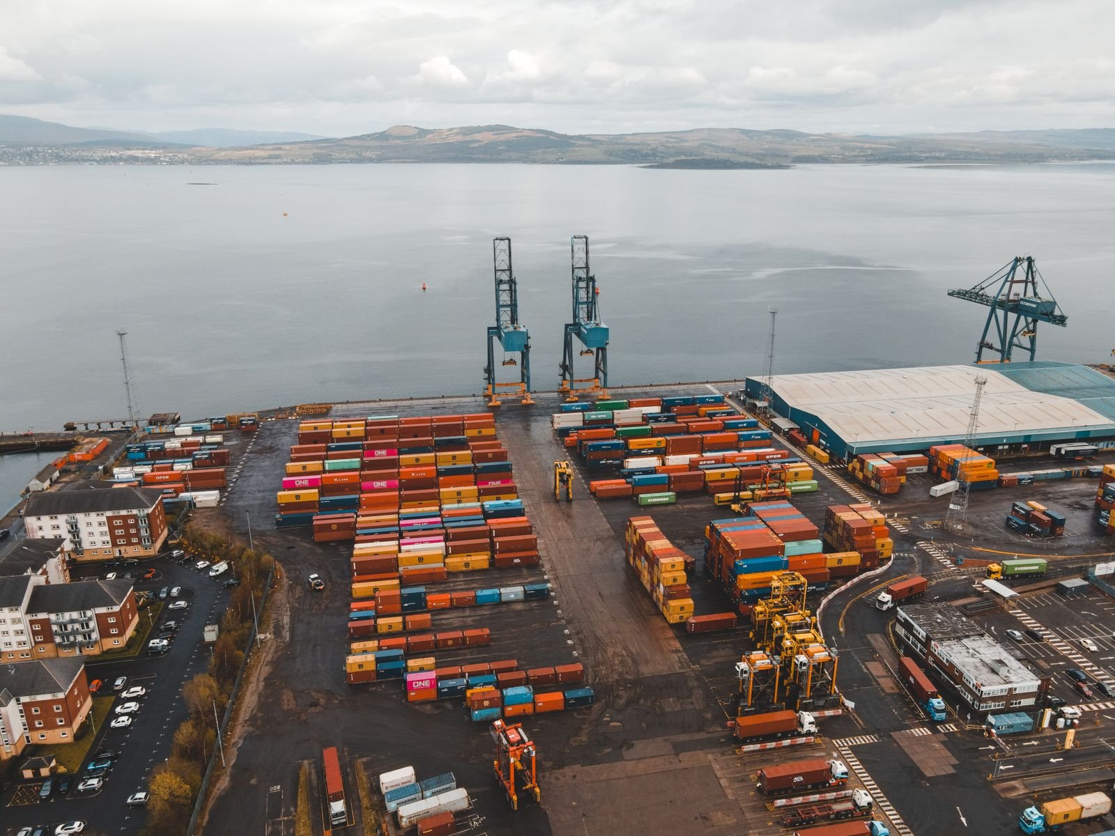 Aerial view of cargo containers beside the ocean