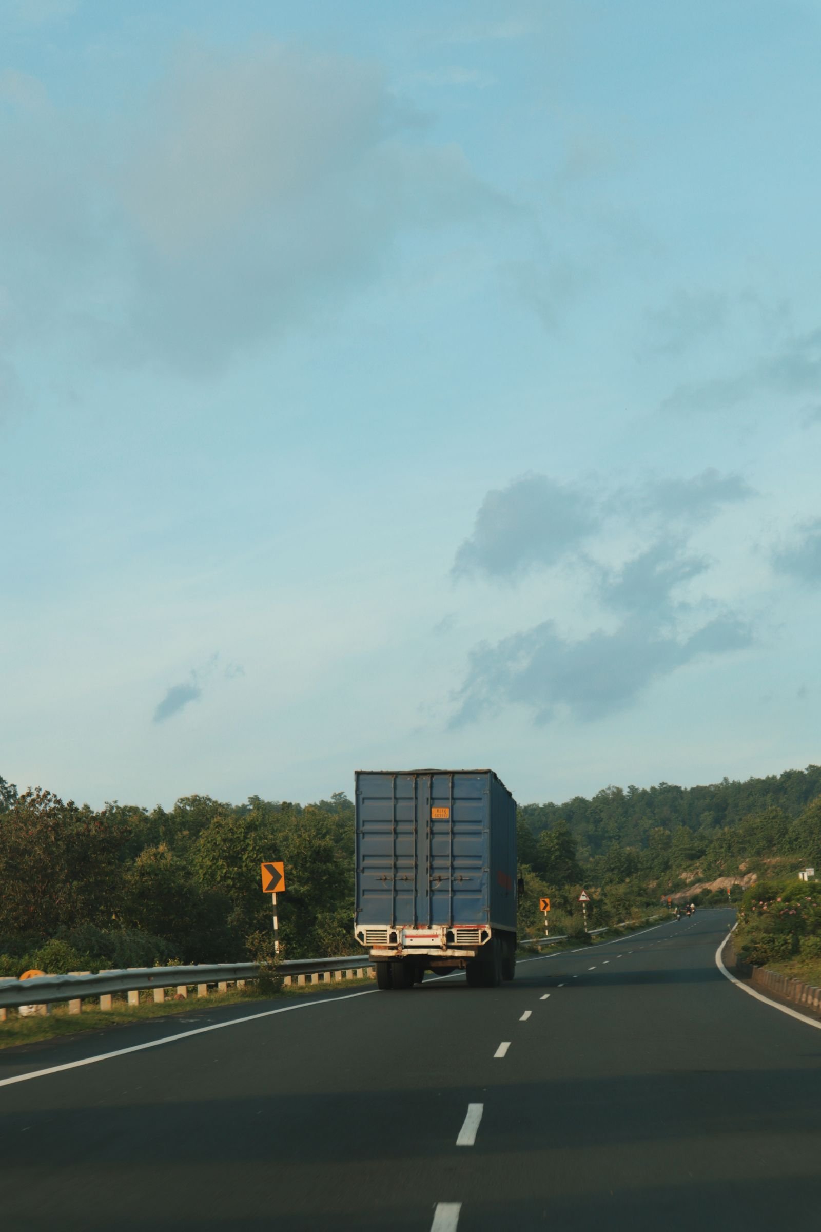 Container truck driving on an empty highway