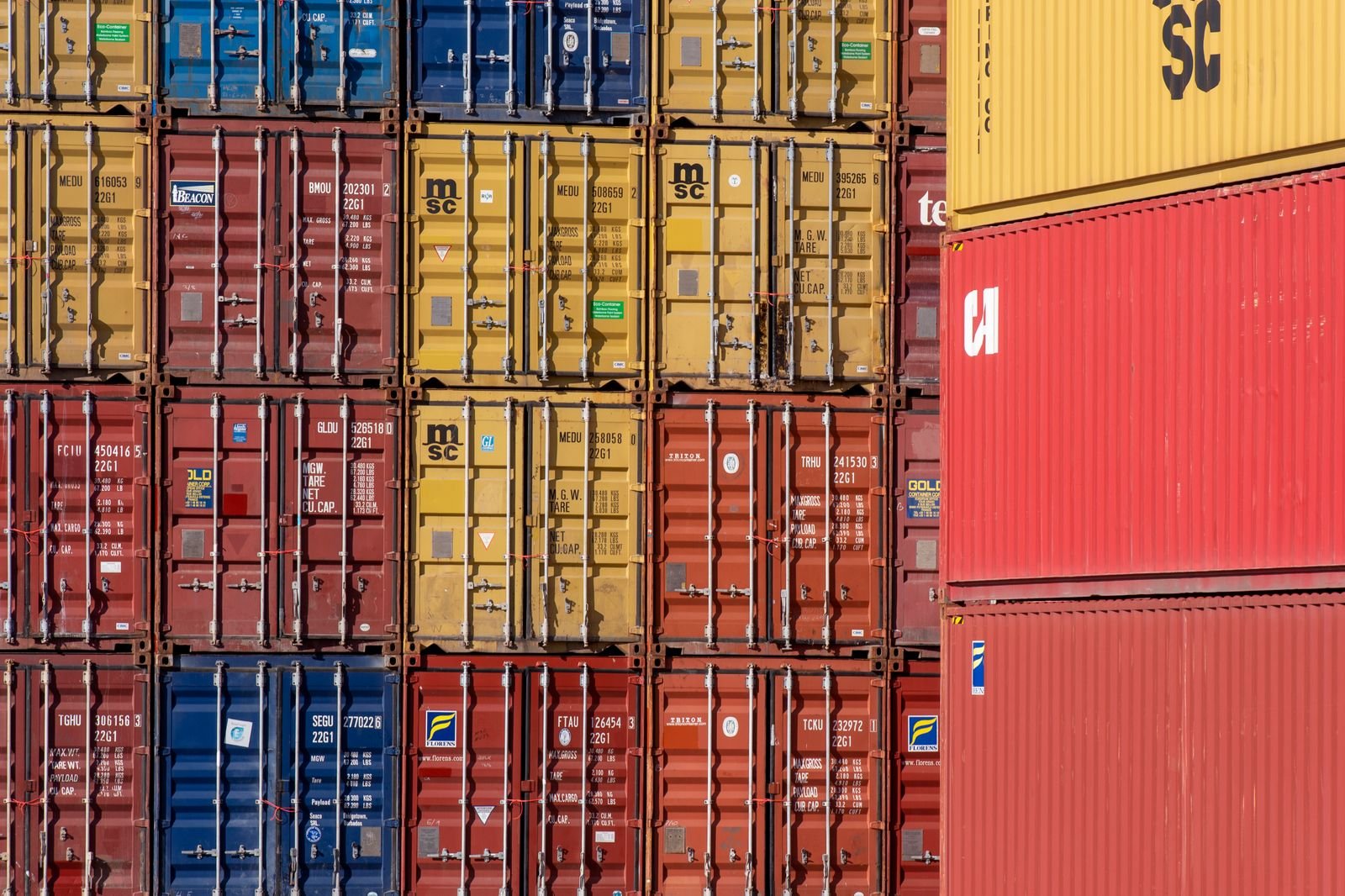 Stacked shipping containers in a port for full container loads