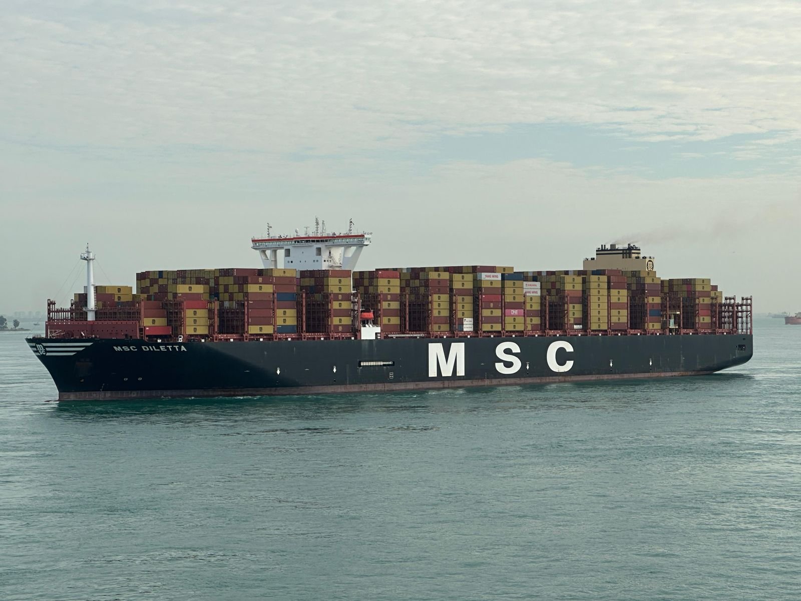 Container ship carrying cargo across the open sea
