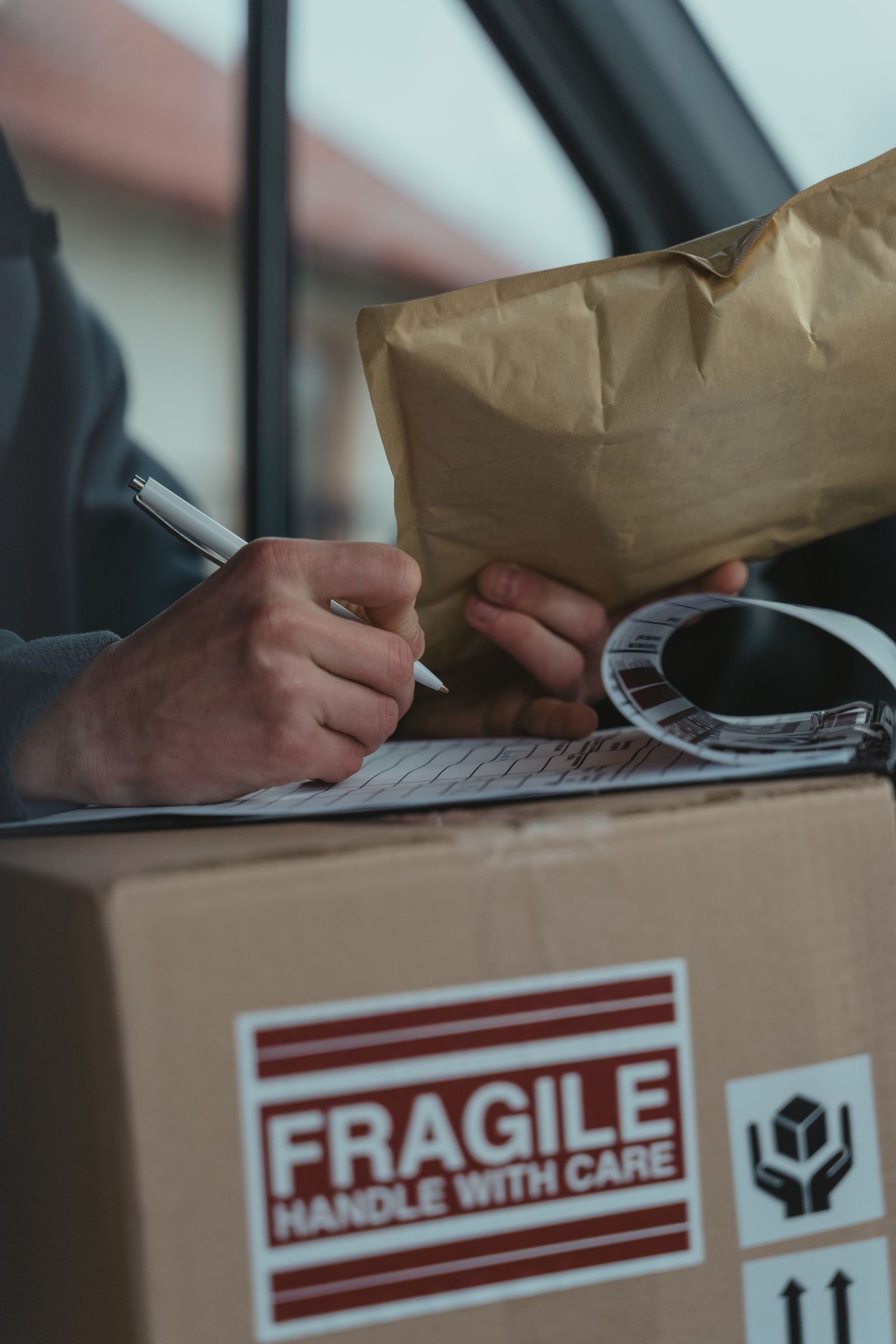 Person completing shipping paperwork on a cargo box