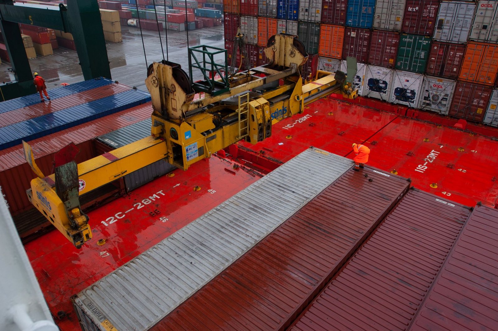 Crane loading full containers at a busy port