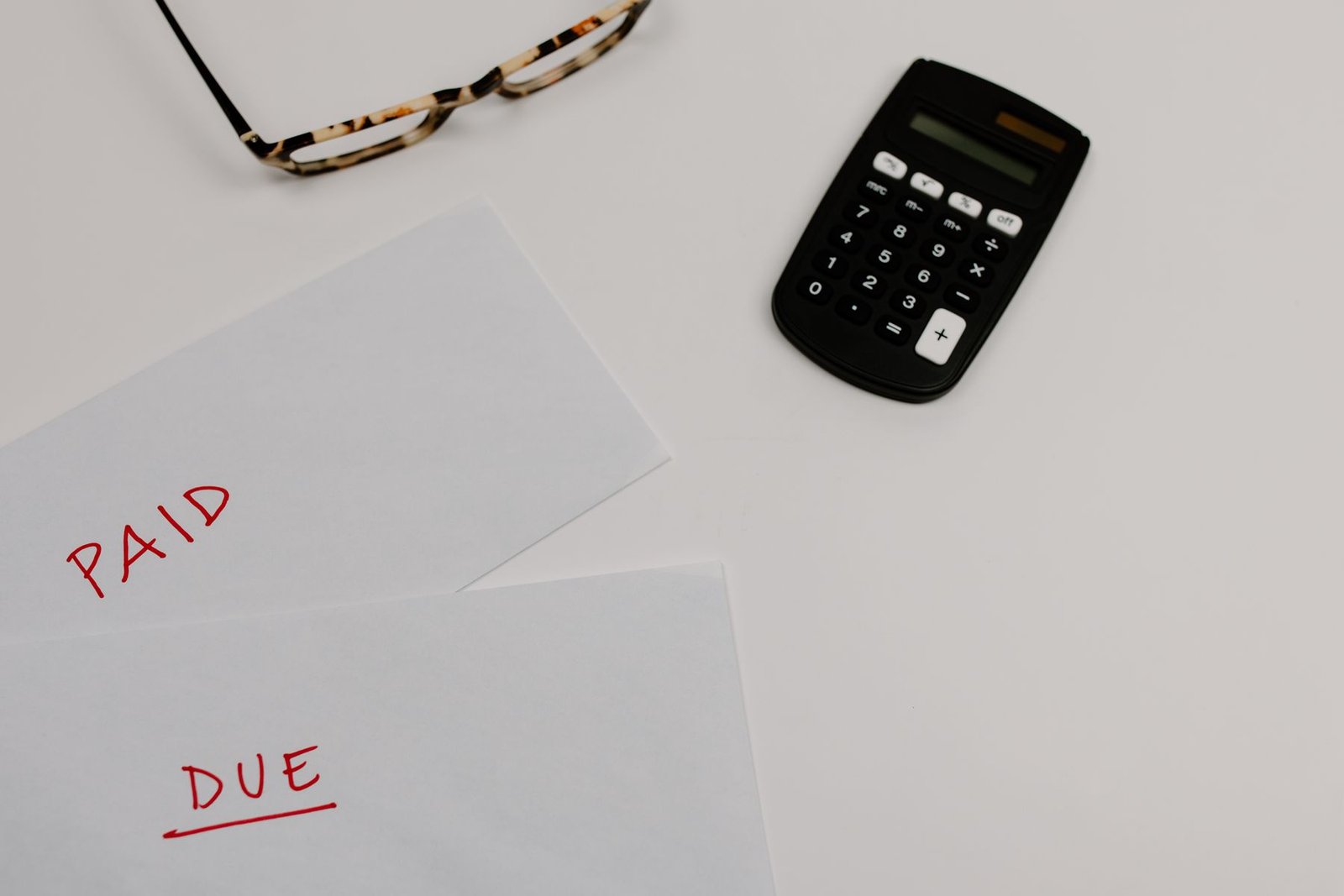 Calculator beside papers for import duty and tax calculation