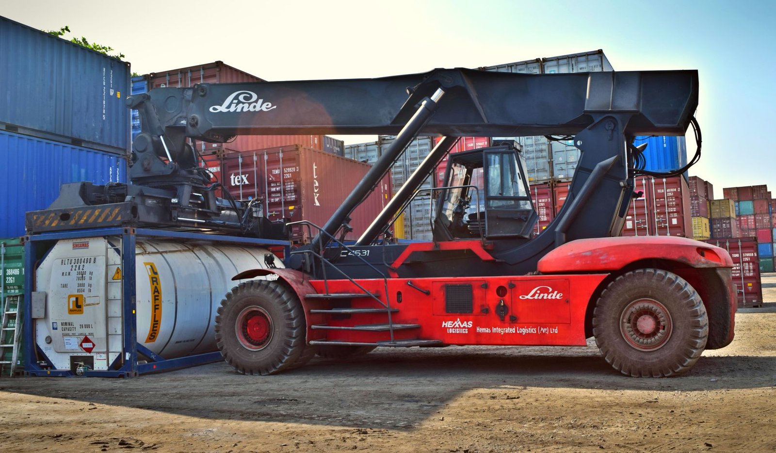 Front loader handling full shipping containers in a container yard