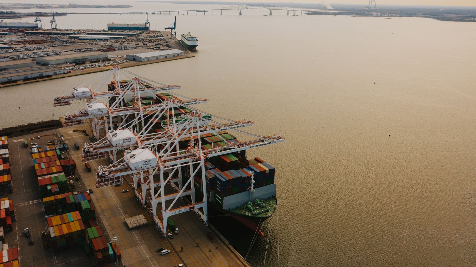 Cranes loading cargo containers onto a ship