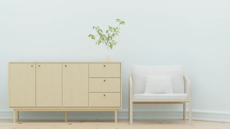 Wooden sideboard beside an armchair