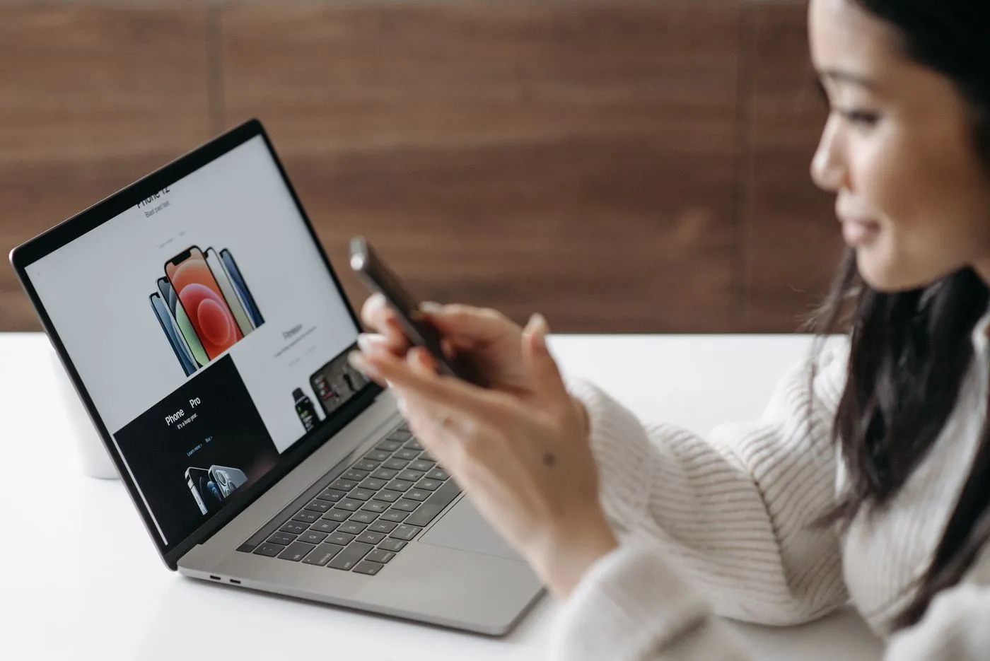 Woman shopping online with a laptop and smartphone