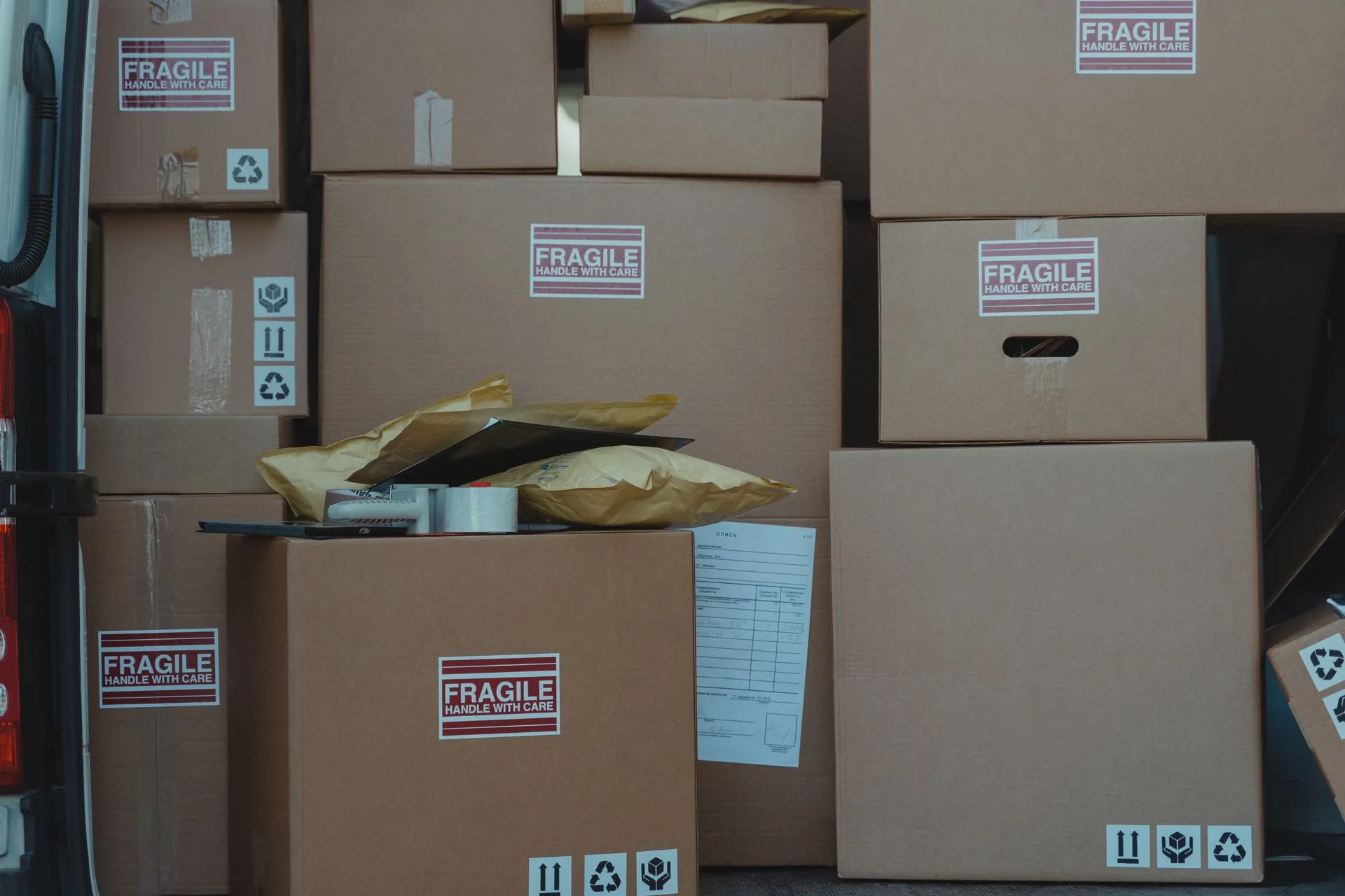 Stacked cartons with fragile labels ready for shipping