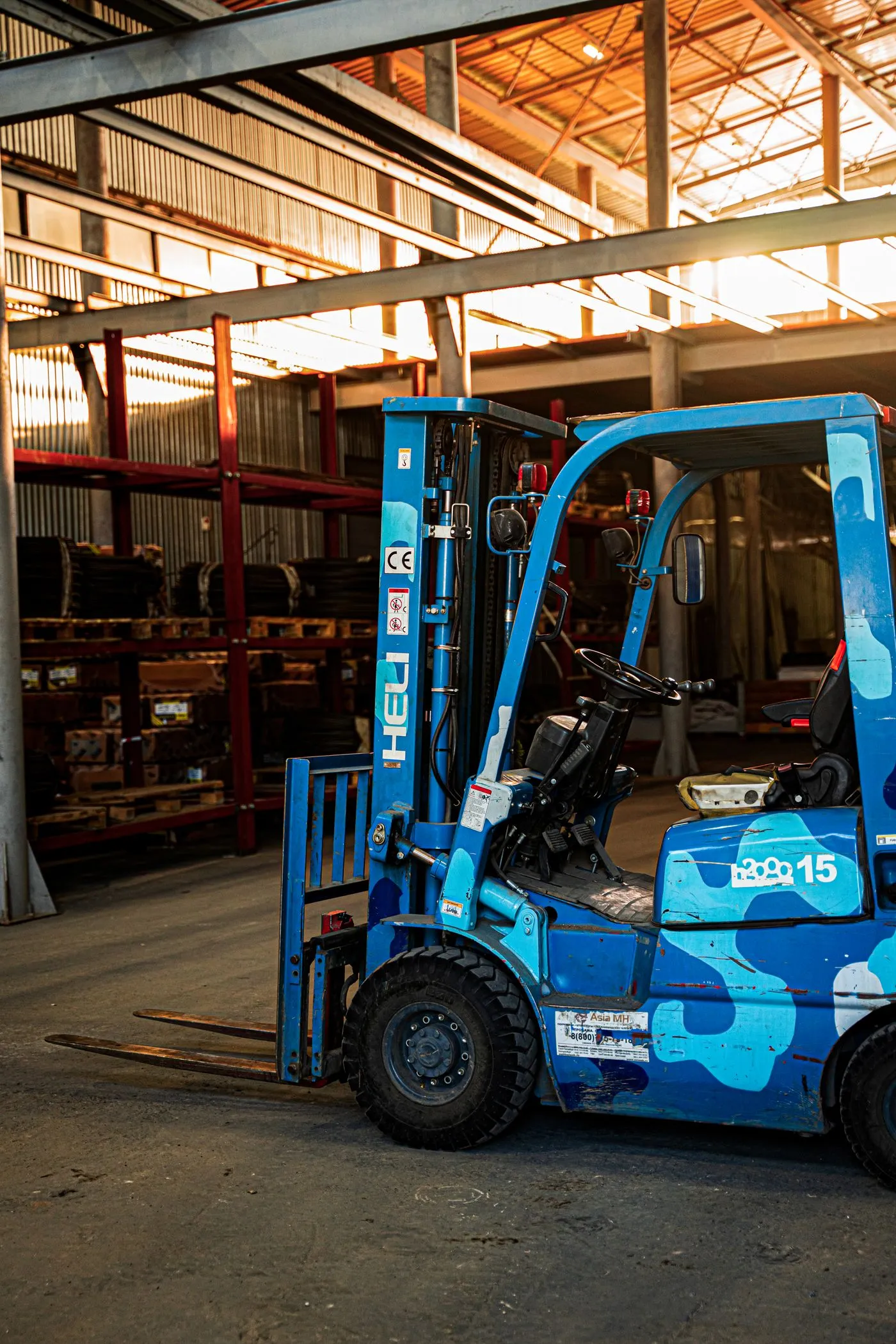 Bright spacious warehouse with a blue forklift